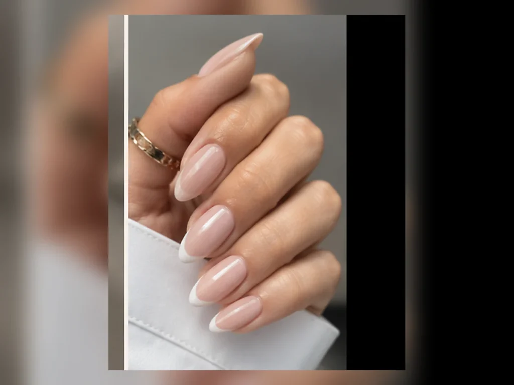 Classic white French tips on almond-shaped nails
