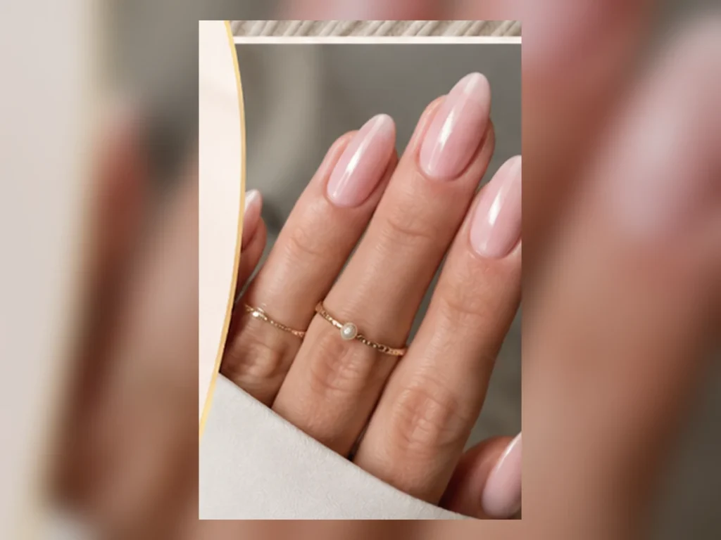 Glossy baby pink almond-shaped manicure