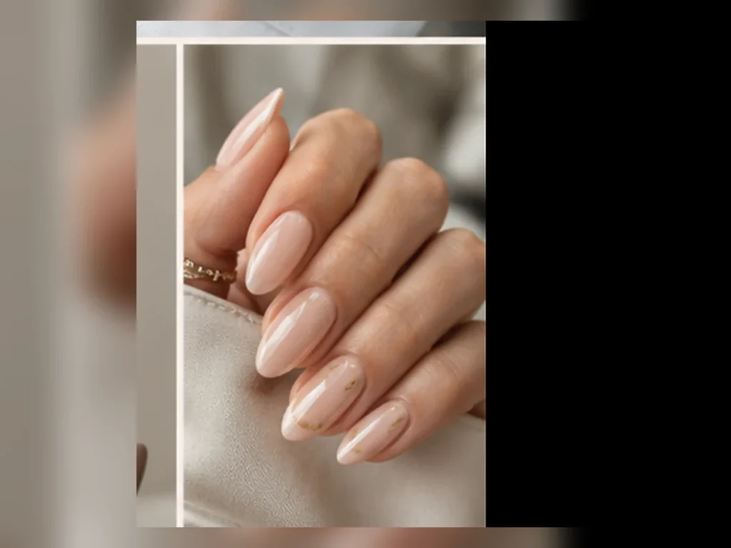 Almond nails with a soft neutral base and delicate gold accent